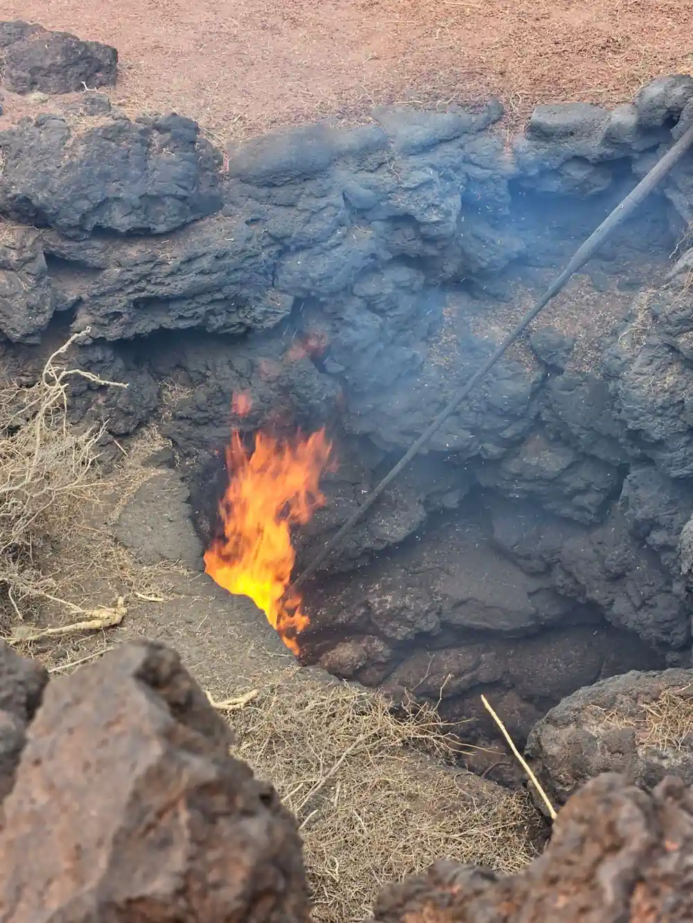 Flames burning from rocks in natural setting