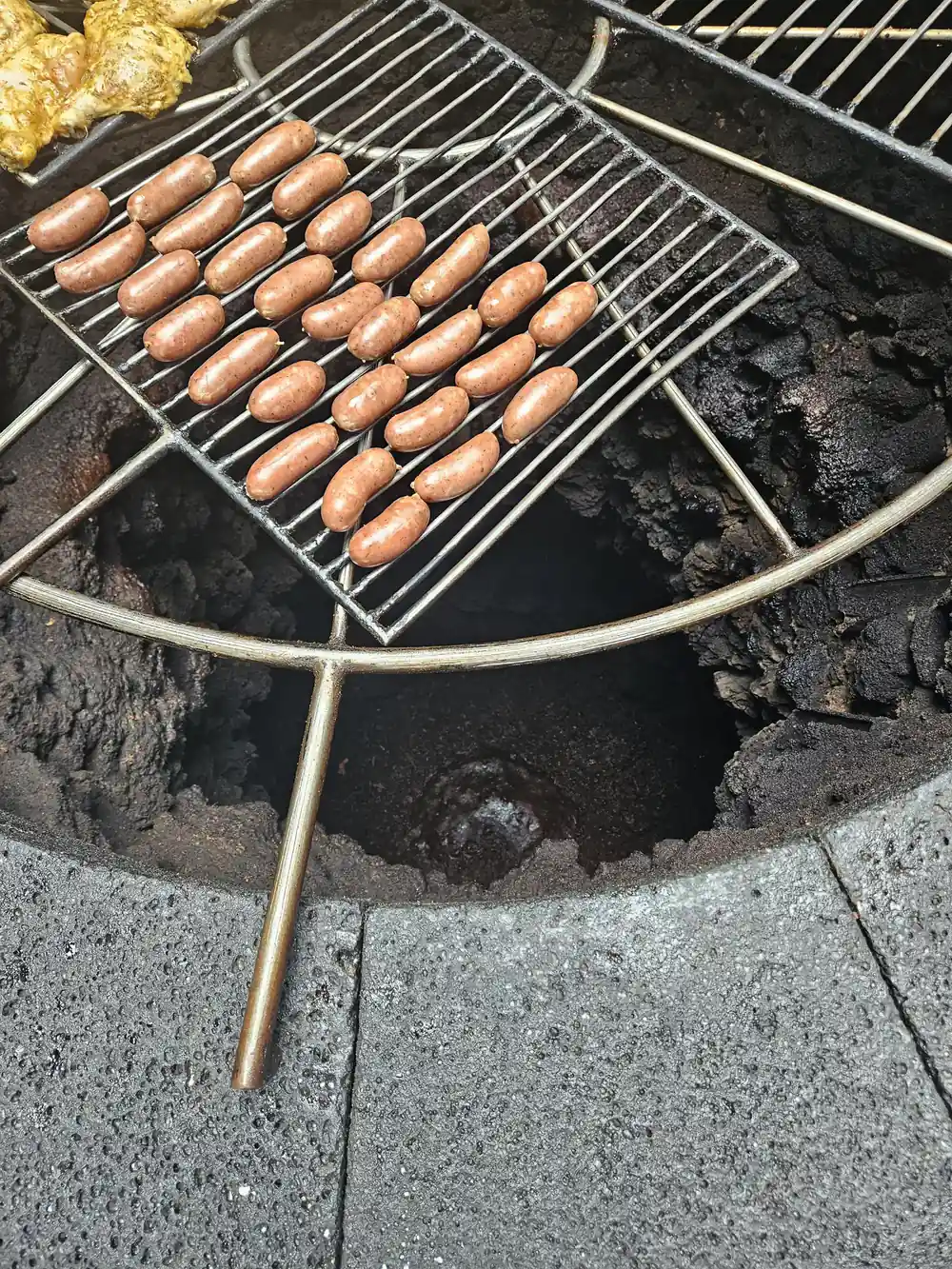 Hot spring grill cooking sausages over geothermal heat