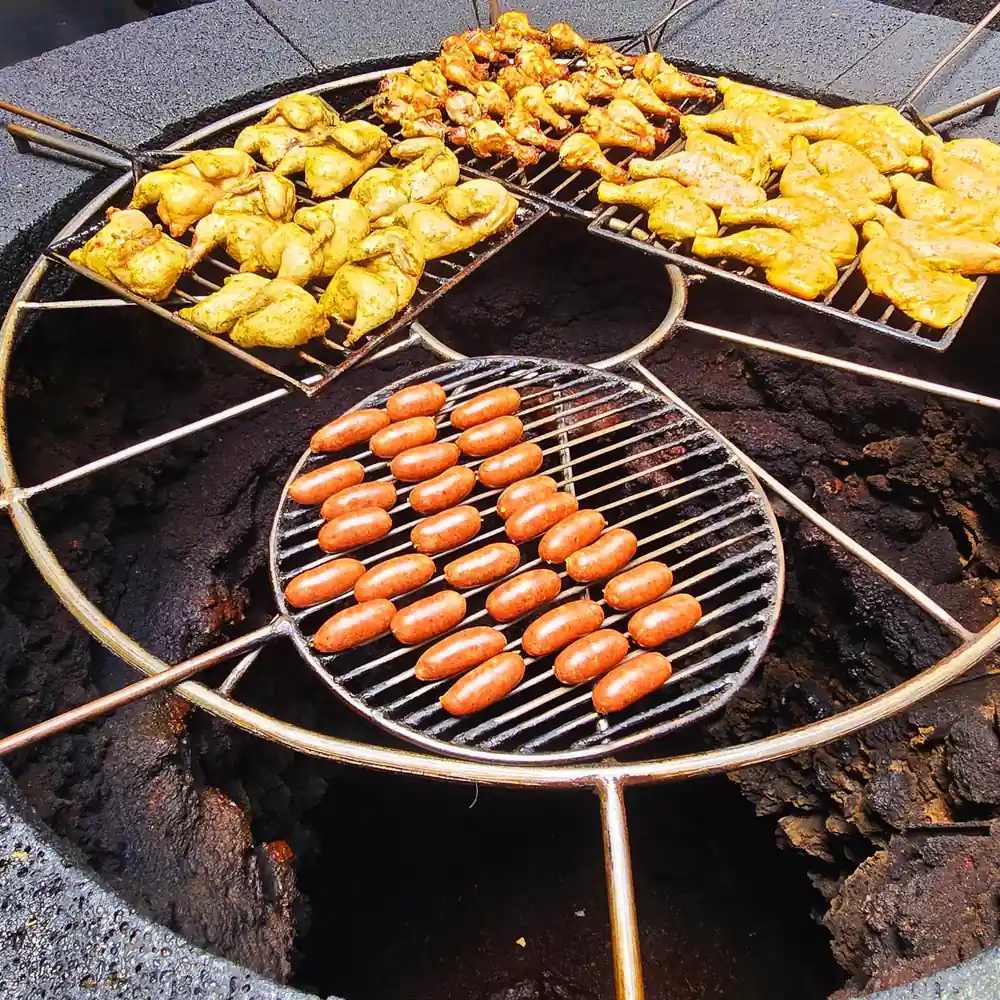 Meat and vegetables cooking on volcanic heat grill