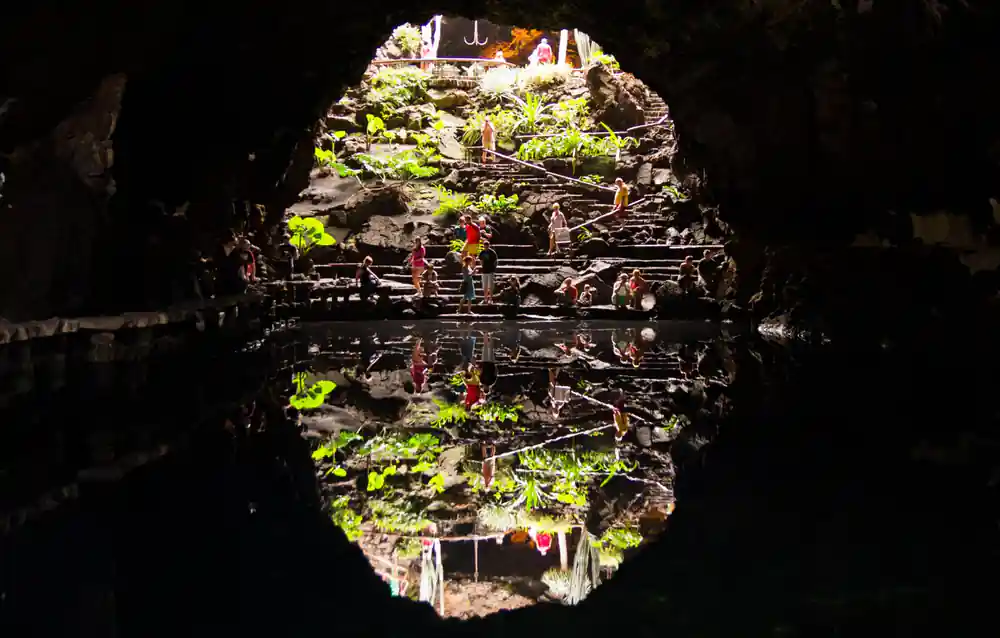 Underground cave opening showing vegetation and sky
