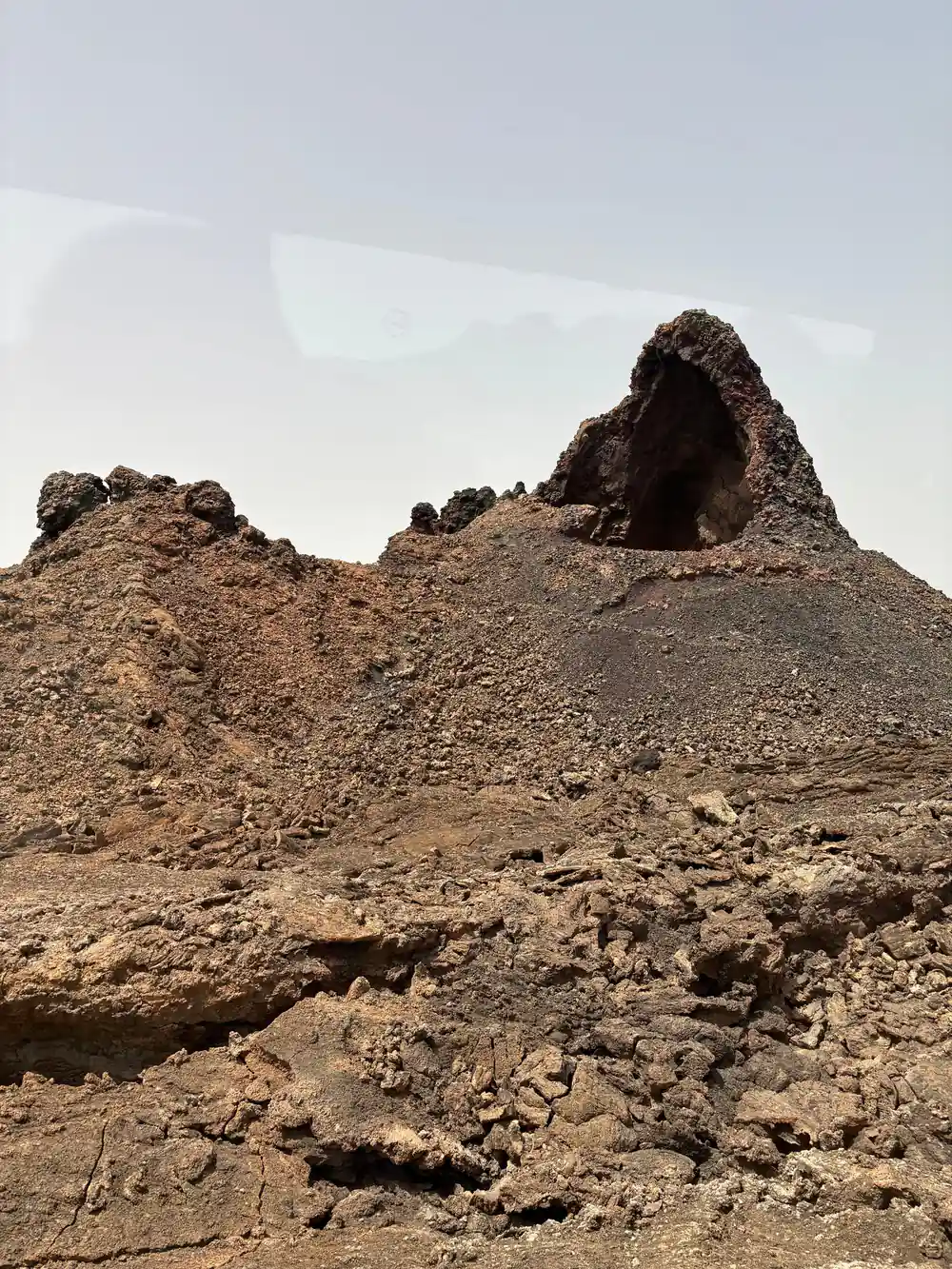 Volcanic cone crater in barren desert landscape