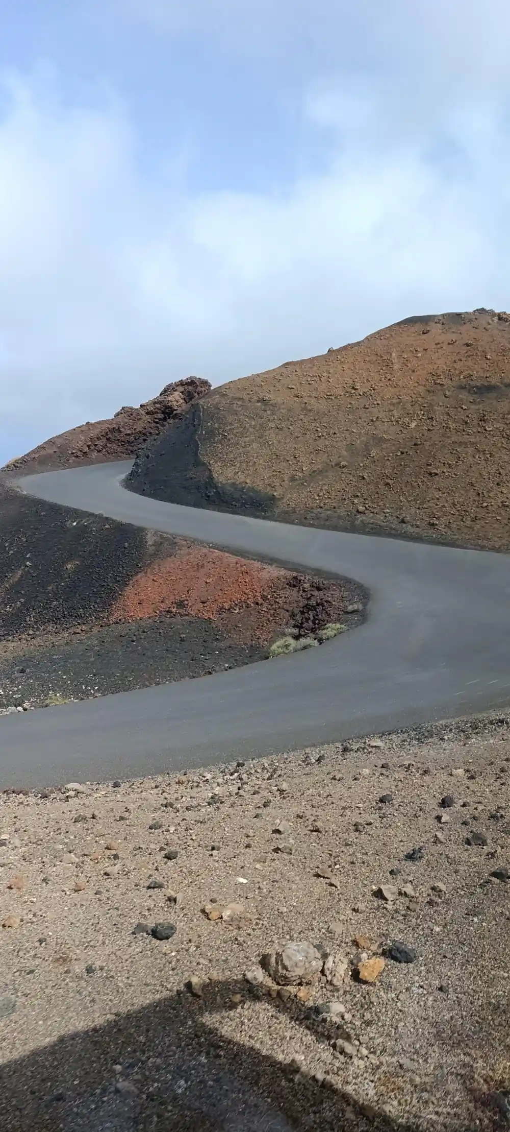 Volcanic crater with dark rock formation and shallow water